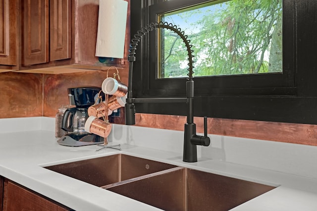 5802 Tennessee Ave, Clarendon Hills, IL 60514 - interior details with brown cabinetry, a sink, decorative backsplash, and light countertops
