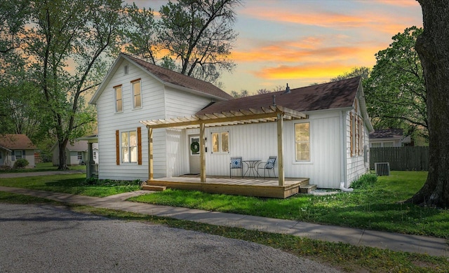 view of front of home with fence, a pergola, a shingled roof, a deck, and central air condition unit