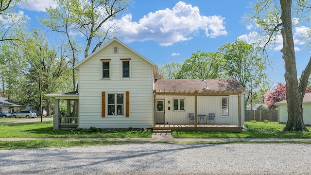 view of front of property with fence and a shingled roof