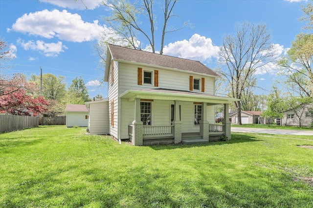 view of front of house with fence, covered porch, and a front lawn