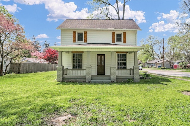 view of front of property featuring fence, a porch, and a front yard