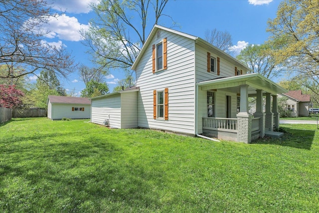 exterior space featuring a porch, a yard, and fence
