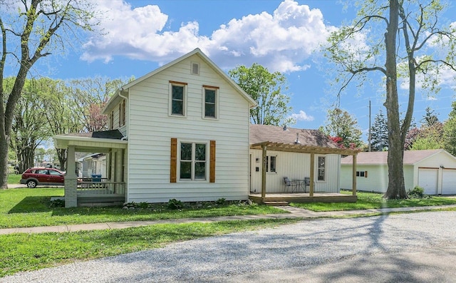 view of front of home with a garage, a wooden deck, a pergola, a front yard, and gravel driveway