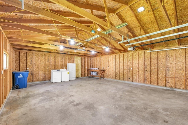 garage featuring separate washer and dryer and a garage door opener