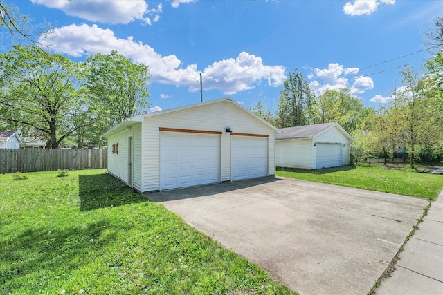 detached garage featuring fence