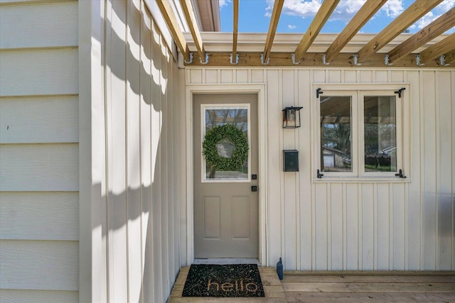 doorway to property featuring board and batten siding