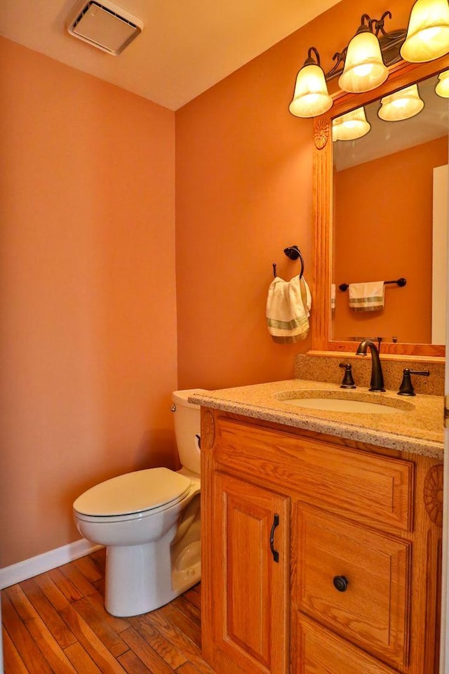 406 Woodcroft Ln, Schaumburg, IL 60173 - bathroom featuring wood finished floors, vanity, baseboards, toilet, and visible vents