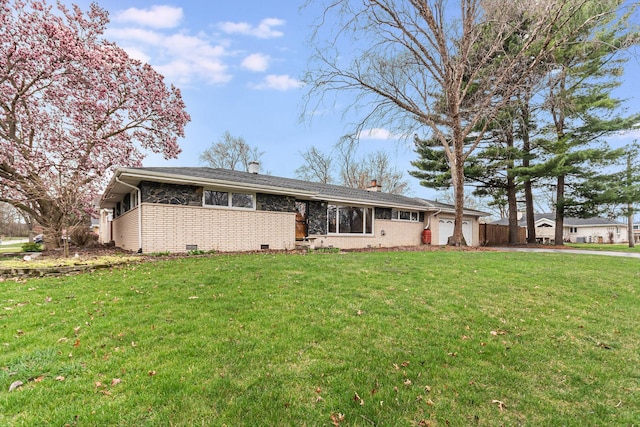 single story home featuring a garage, a chimney, a front lawn, and brick siding
