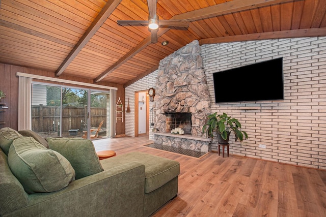 living area with wood ceiling, lofted ceiling with beams, a ceiling fan, and wood finished floors