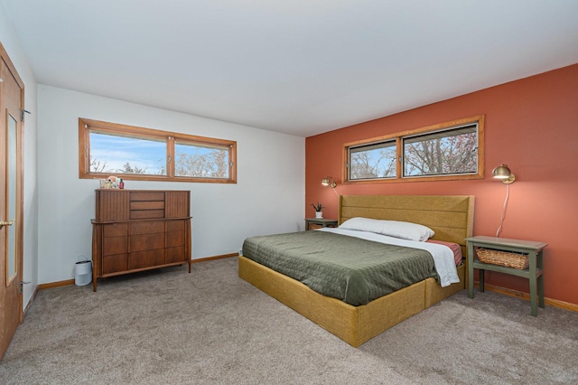 carpeted bedroom featuring baseboards