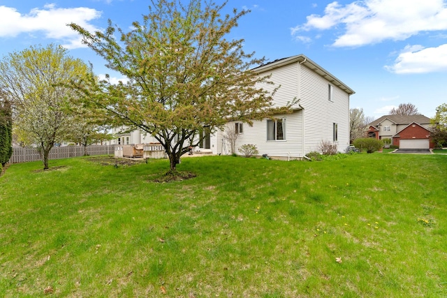 exterior space with fence and a yard
