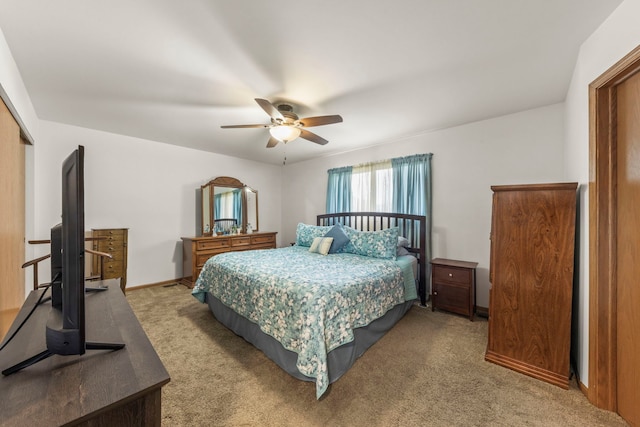carpeted bedroom featuring baseboards, a ceiling fan, and a closet