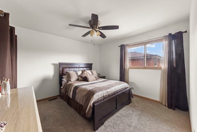 bedroom with a ceiling fan, baseboards, visible vents, and light carpet