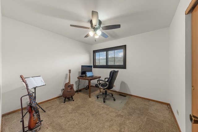 office area with baseboards, carpet flooring, ceiling fan, and visible vents