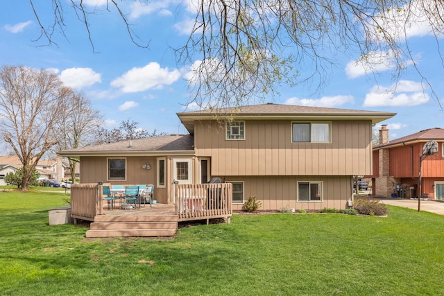 back of house featuring a wooden deck and a yard