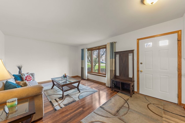 living area featuring baseboards and wood finished floors
