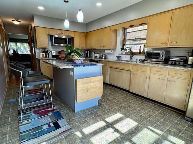 4941 N Kilpatrick Ave, Chicago, IL 60630 - kitchen with appliances with stainless steel finishes, plenty of natural light, a sink, and a toaster
