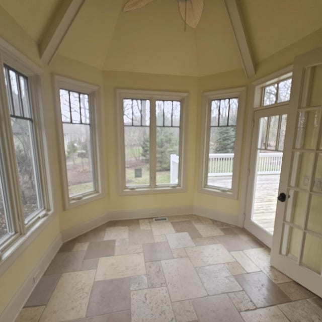 9065 Edinburgh Ct, Lakewood, IL 60014 - unfurnished sunroom featuring baseboards, lofted ceiling with beams, a healthy amount of sunlight, and stone tile flooring
