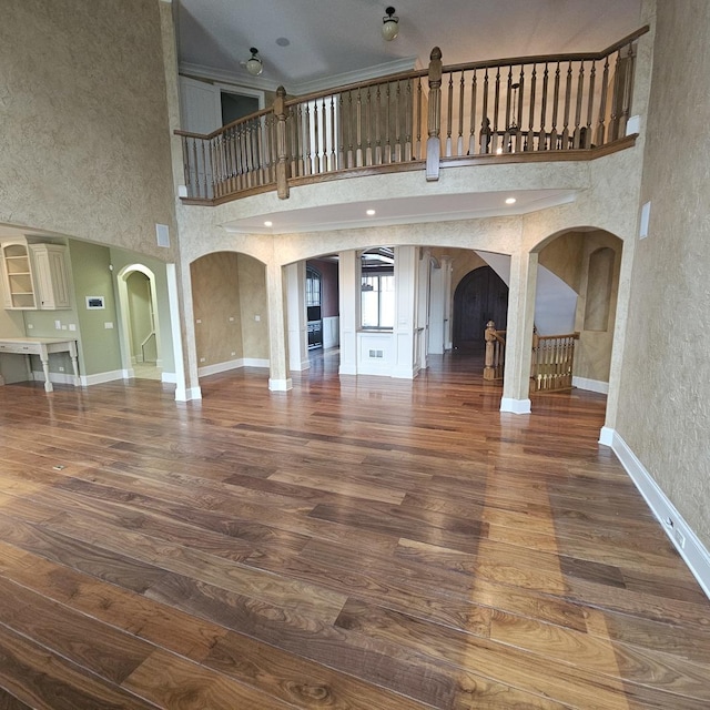 9065 Edinburgh Ct, Lakewood, IL 60014 - unfurnished living room with baseboards, arched walkways, and wood finished floors