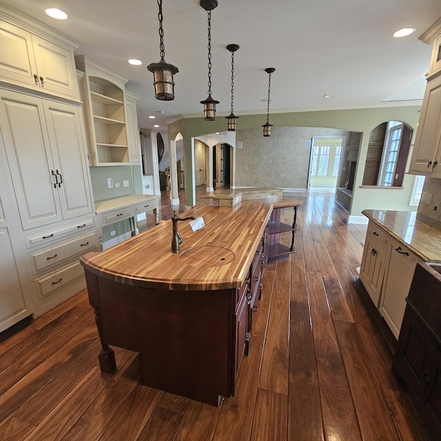 9065 Edinburgh Ct, Lakewood, IL 60014 - kitchen featuring wooden counters, arched walkways, open shelves, dark wood finished floors, and open floor plan