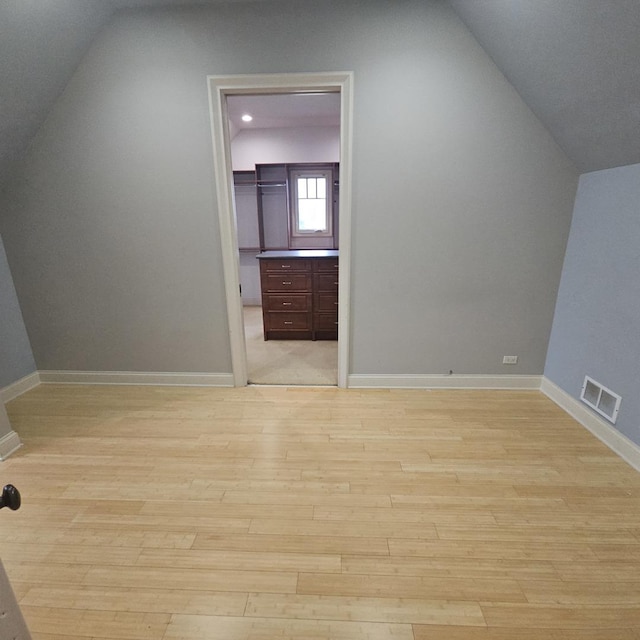 9065 Edinburgh Ct, Lakewood, IL 60014 - additional living space featuring baseboards, lofted ceiling, light wood finished floors, and visible vents
