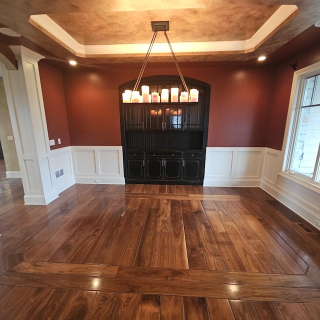 9065 Edinburgh Ct, Lakewood, IL 60014 - unfurnished dining area with a tray ceiling, visible vents, dark wood-style floors, and a decorative wall