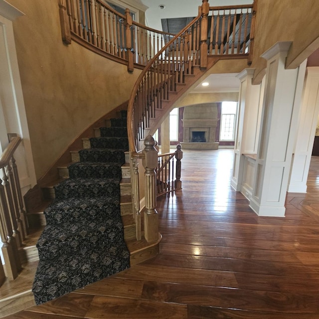 9065 Edinburgh Ct, Lakewood, IL 60014 - stairway with a fireplace with raised hearth, a high ceiling, and hardwood / wood-style floors