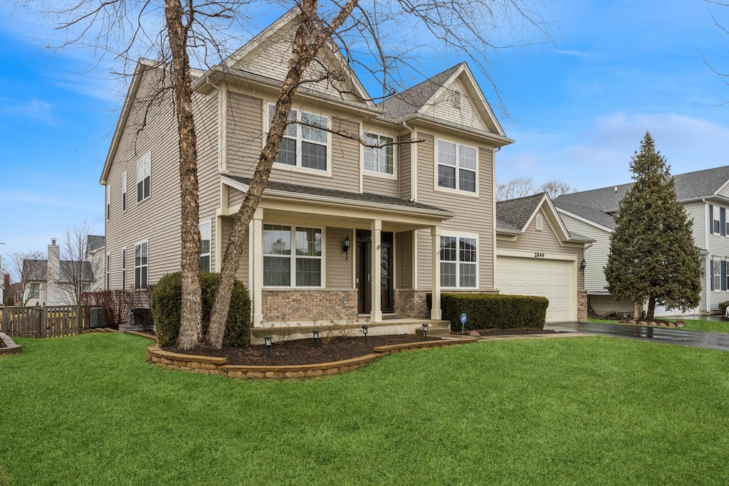 2849 Sweet Clover Way, Wauconda, IL 60084 - view of front of home featuring fence, a front lawn, roof with shingles, brick siding, and a garage