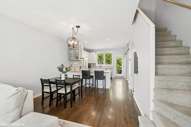 dining area with a notable chandelier, stairs, recessed lighting, baseboards, and dark wood-style floors