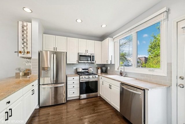 kitchen with recessed lighting, a sink, white cabinetry, and stainless steel appliances