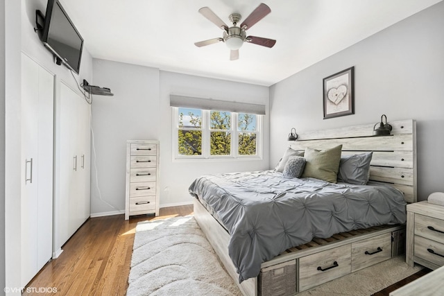 bedroom with baseboards, a ceiling fan, and wood finished floors