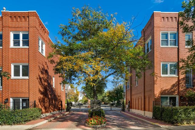 view of street with sidewalks, a gated entry, a gate, and curbs