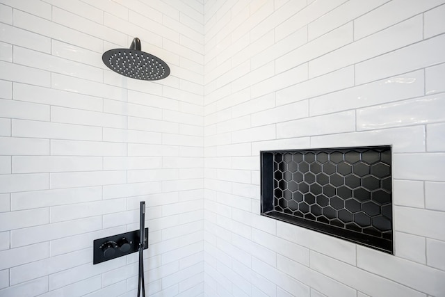 interior details featuring tiled shower