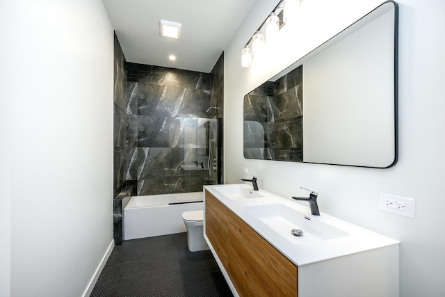 bathroom with toilet, double vanity, a sink, and tub / shower combination
