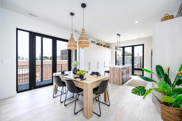 dining area featuring recessed lighting, visible vents, french doors, and light wood-type flooring
