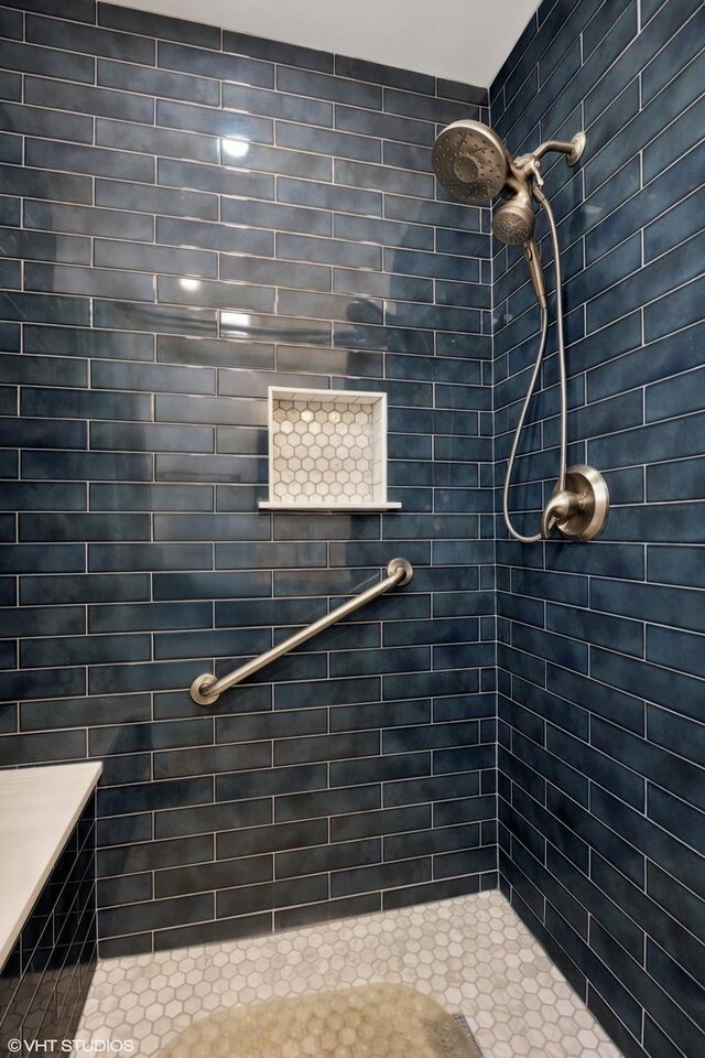 bathroom with tiled shower
