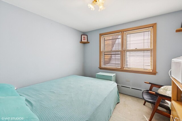 bedroom featuring a baseboard radiator and light carpet