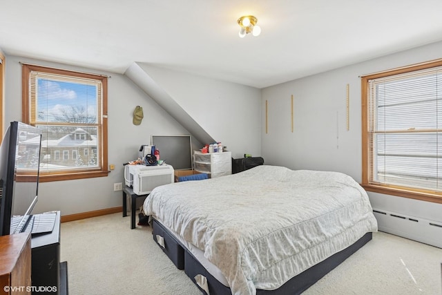 bedroom with a baseboard radiator, baseboards, light colored carpet, and multiple windows