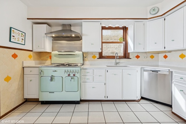 kitchen with stainless steel dishwasher, a sink, wallpapered walls, wall chimney exhaust hood, and gas stove