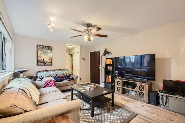 living room with a ceiling fan and wood finished floors