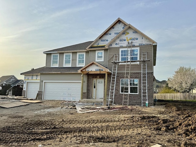 view of front of property featuring an attached garage and brick siding