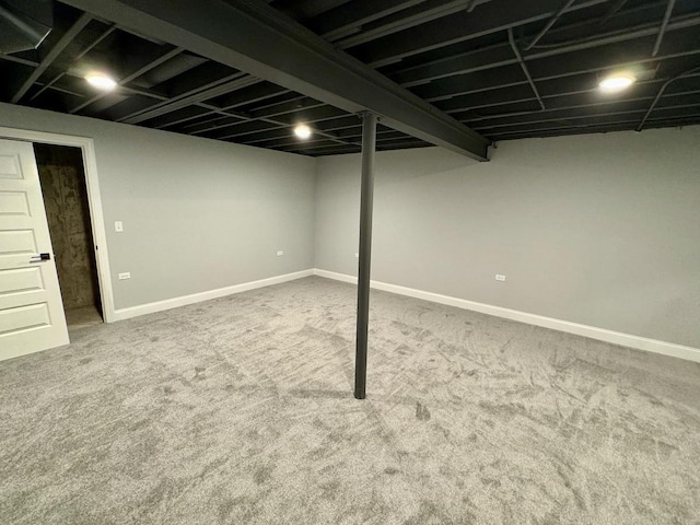 finished below grade area featuring baseboards and carpet floors