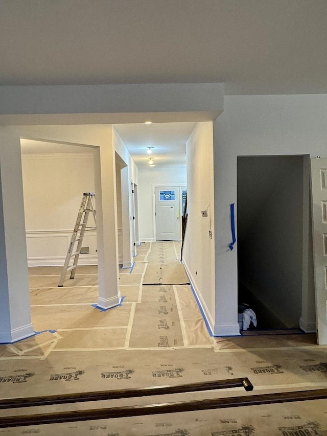 hall featuring baseboards