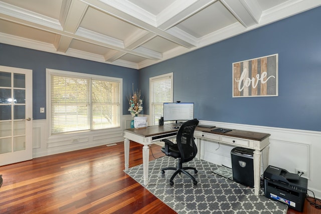 home office featuring beamed ceiling, a wainscoted wall, coffered ceiling, wood finished floors, and crown molding
