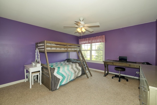 carpeted bedroom with baseboards, an office area, and ceiling fan