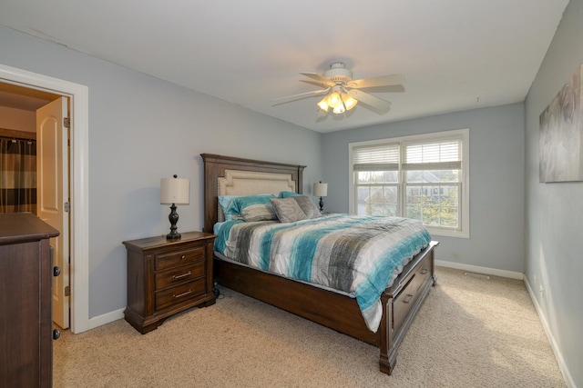 bedroom featuring light carpet, baseboards, and a ceiling fan