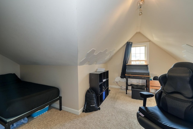 sitting room featuring vaulted ceiling, baseboards, and carpet