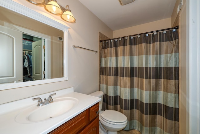 full bathroom with toilet, vanity, and a shower with curtain