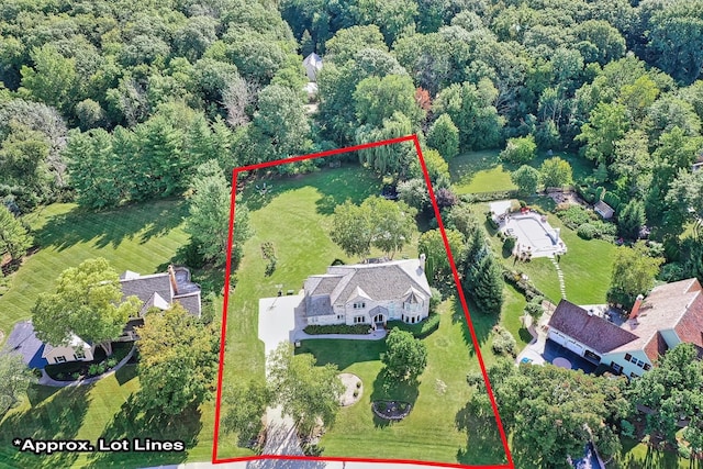 drone / aerial view featuring a wooded view