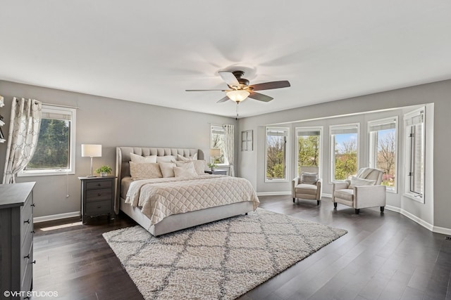 bedroom with baseboards, a ceiling fan, and dark wood-style flooring